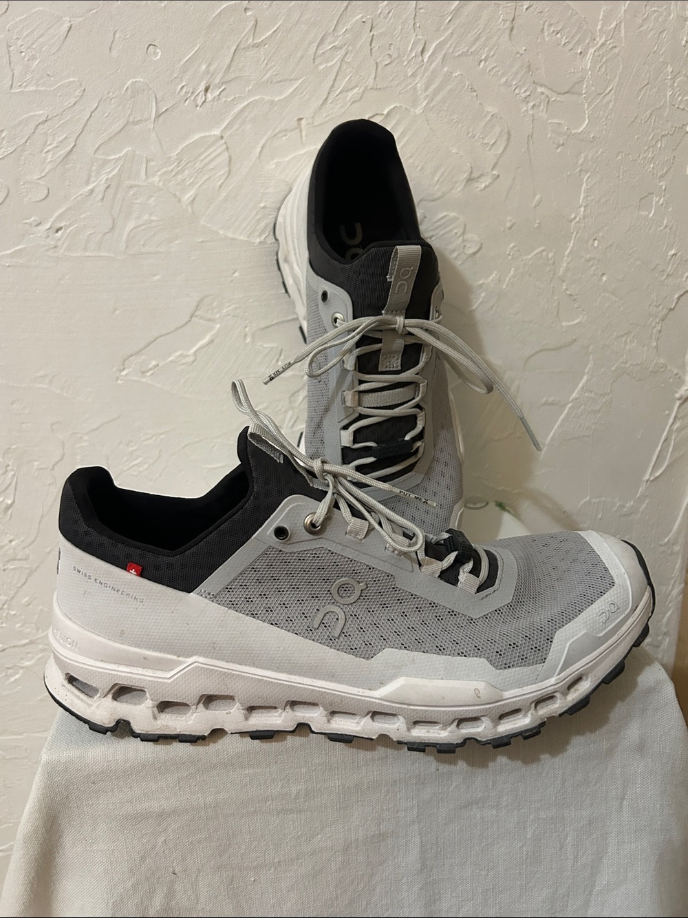 On Cloud women's Trail Runners in Light Gray and Black